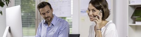 Male and female project manager collaborating in front of computer screen at office