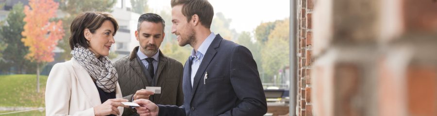 Business people talking and exchanging business cards