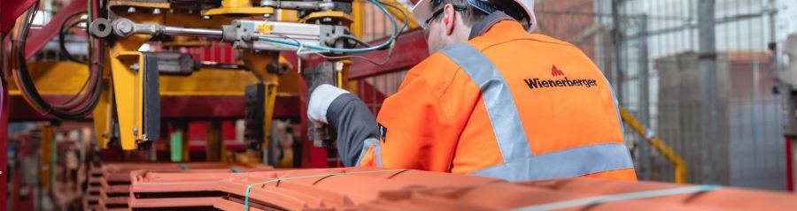 Factory worker checking packaging machine