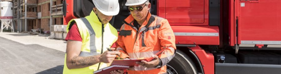 Construction worker signs delivery slip